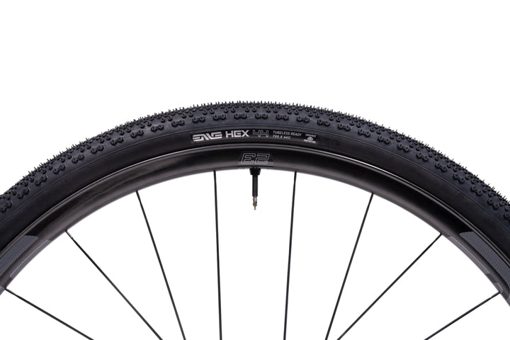 Bicycle tire with tread pattern and brand name on a white background